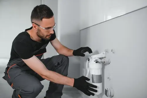 Technician performing water treatment maintenance service in Broward, FL ensuring reliable system upkeep and consistent water filtration performance
