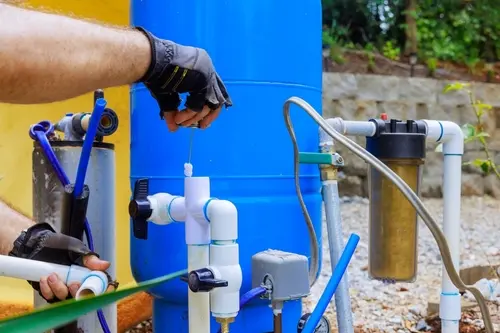 Technician servicing a well water system in Broward, FL ensuring proper filtration, maintenance, and improved water quality performance