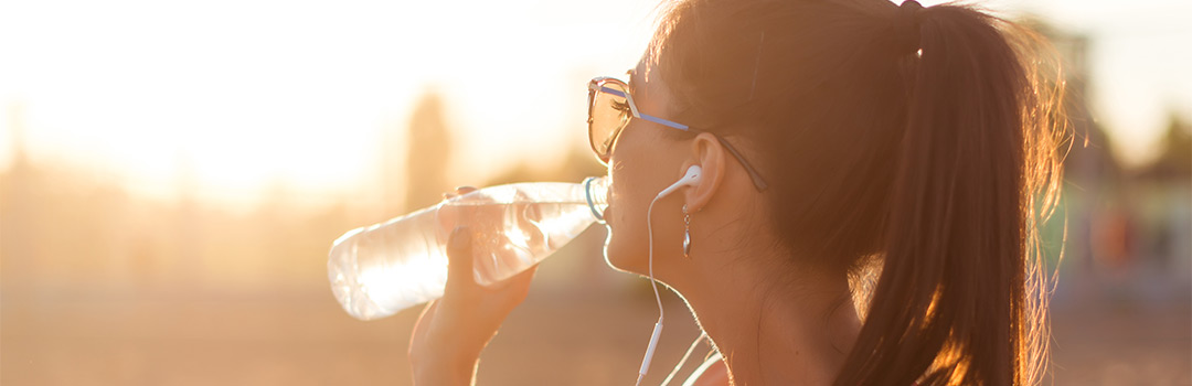 woman drinking water from a bottle